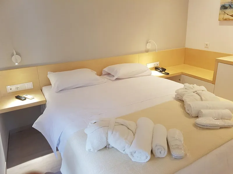 Room 2: the double bed with folded towels