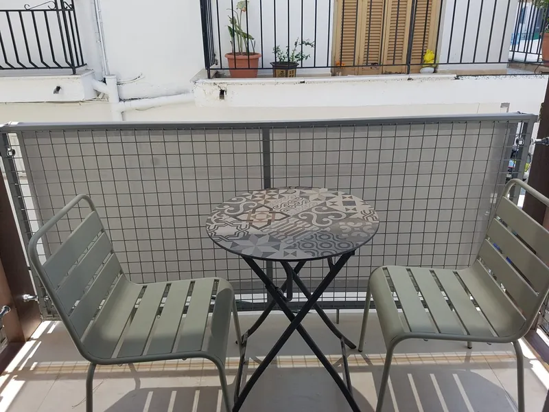 Room 5: the balcony with a table and two chairs